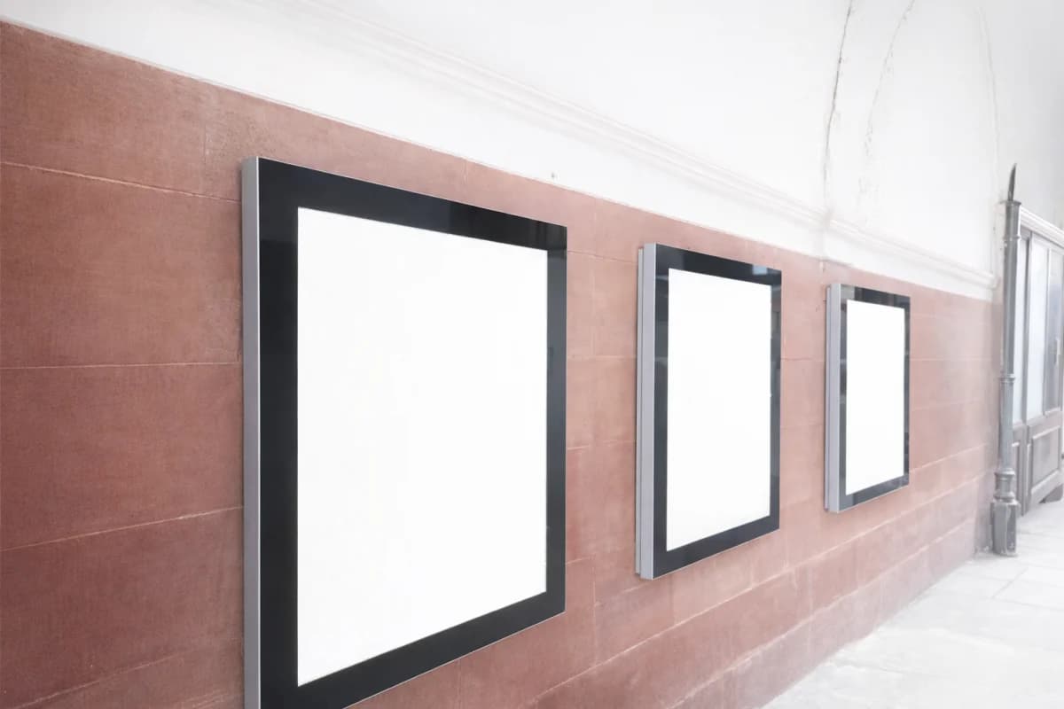 Illuminated ULTRA displays on sandstone corridor wall