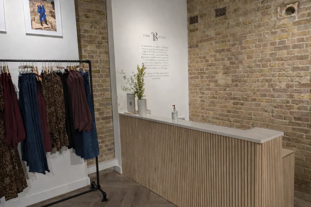 Custom birch wood retail desk with slatted detailing by CVB Technical Solutions